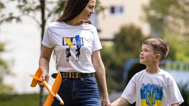 Eine junge Frau mit einem Modellflugzeug in der Hand und ein Junge gehen spazieren